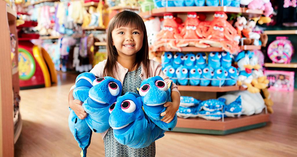 Little Girl in a Disney Store with Dory Plush Toys Small