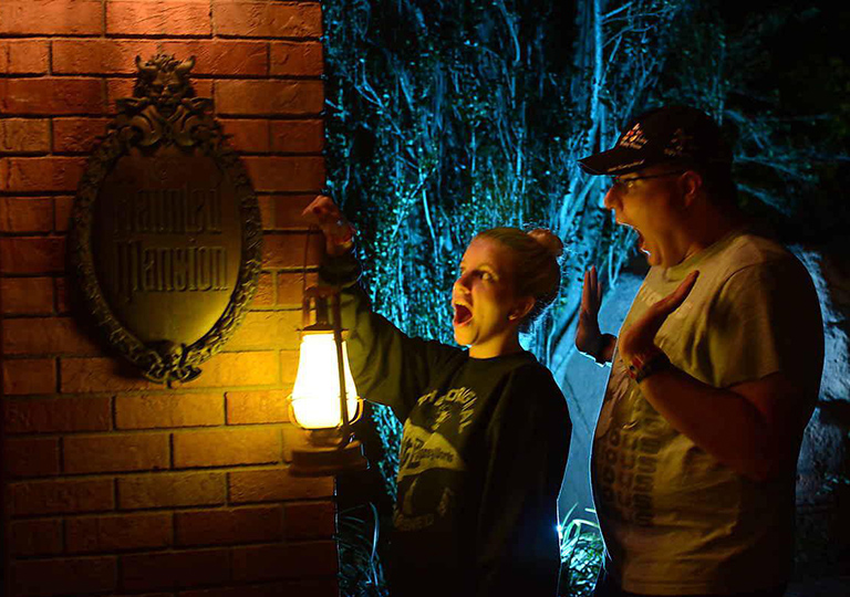 brother and sister at Disney's Haunted Mansion attraction