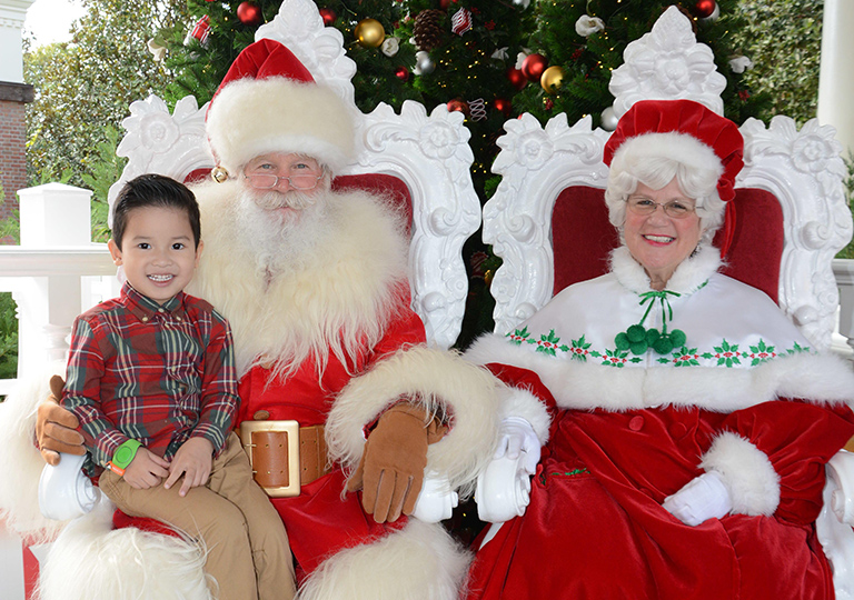 boy with Santa and Mrs Clause at Disney