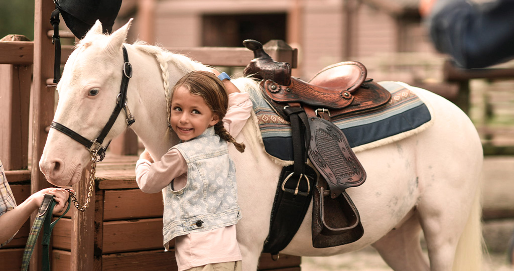 Disney girl hugging a white horse