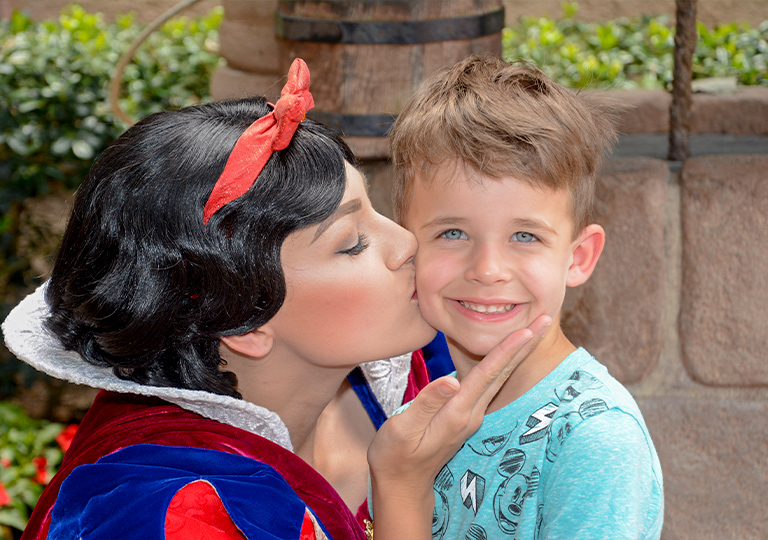 Boy getting a kiss from Snow White