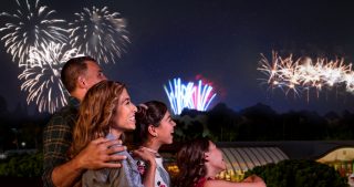 Family at Disneyland watching fireworks from their hotel