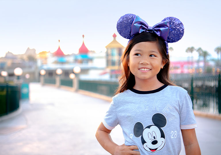 girl posing with Disney gear on