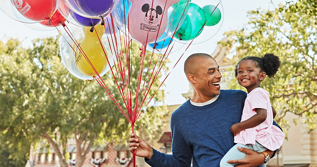 Disney dad and daughter with balloons