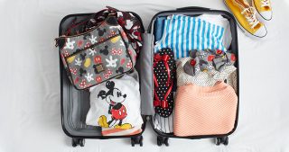 packed suitcase with Disney gear