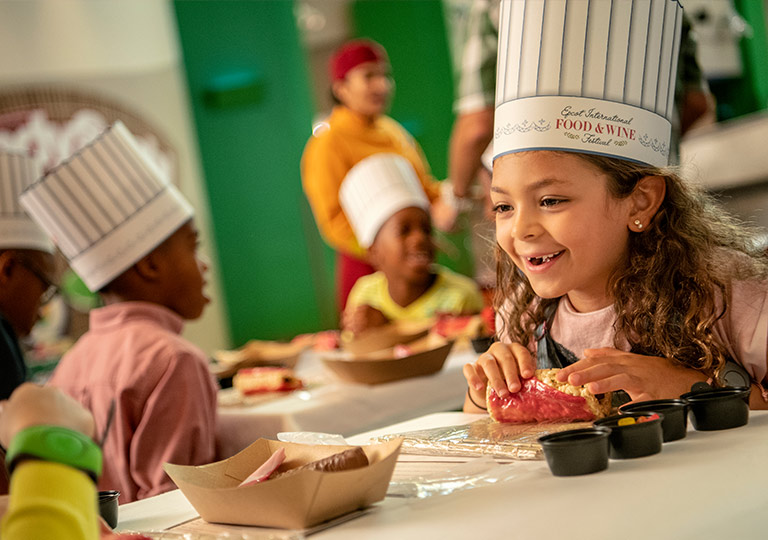 Girl making candy sushi at Epcot