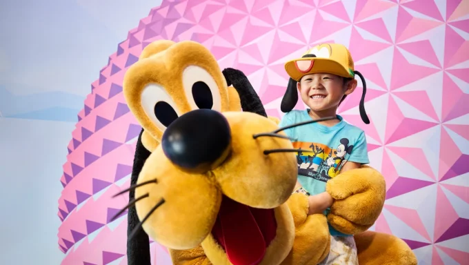 boy with pluto at walt disney world