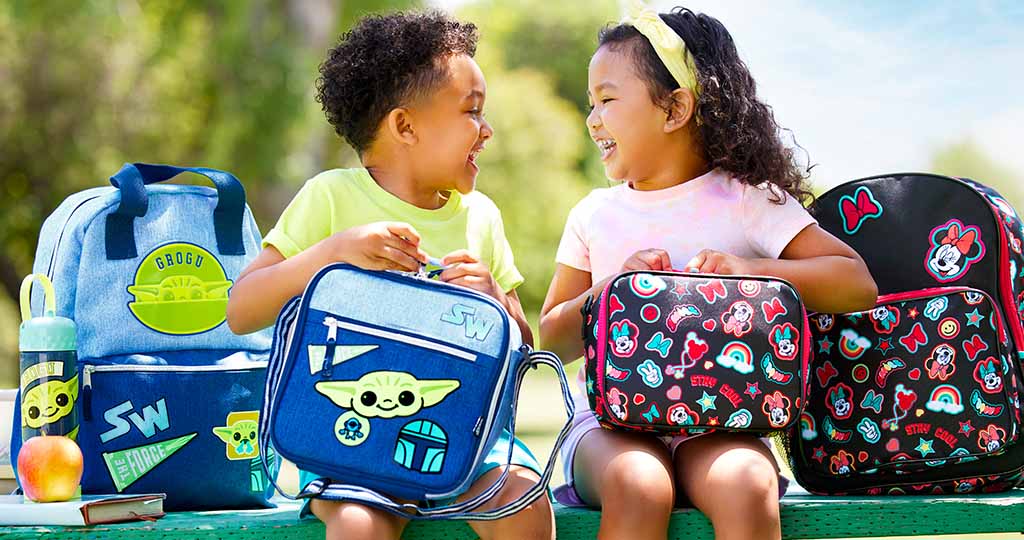Two kids with school supplies