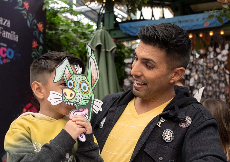 Boy holding an alebrije mask