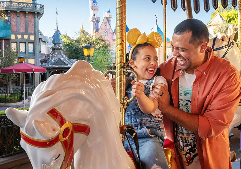 Father and daughter on carousel