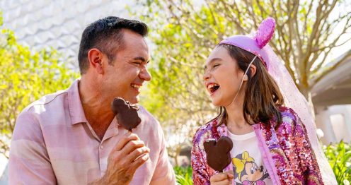 Father daughter smiling with Mickey Ice Cream bars