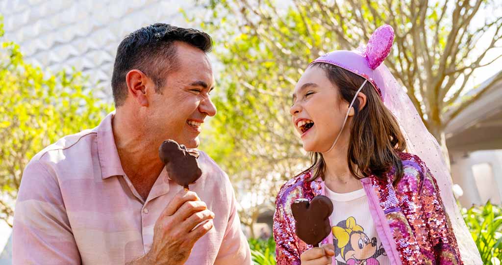 Father daughter smiling with Mickey Ice Cream bars