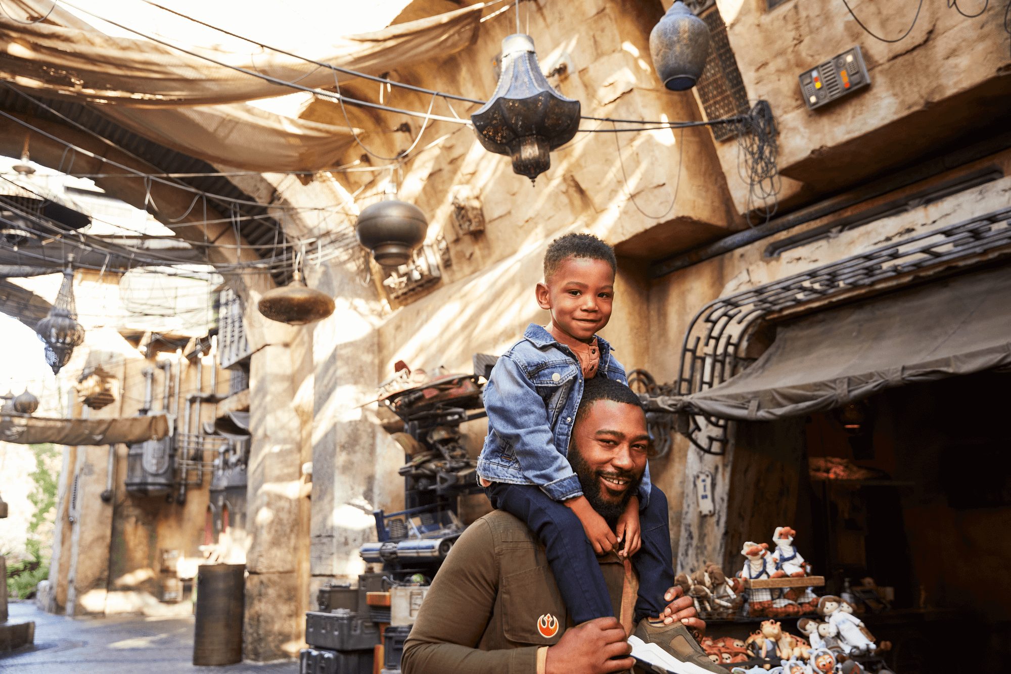 Boy sitting on father's shoulders