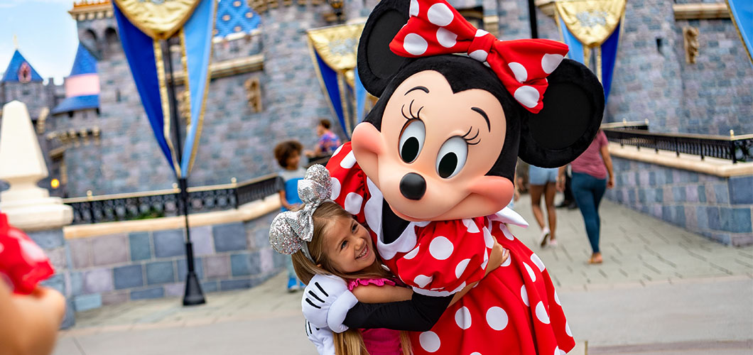 Girl hugging Minnie Mouse