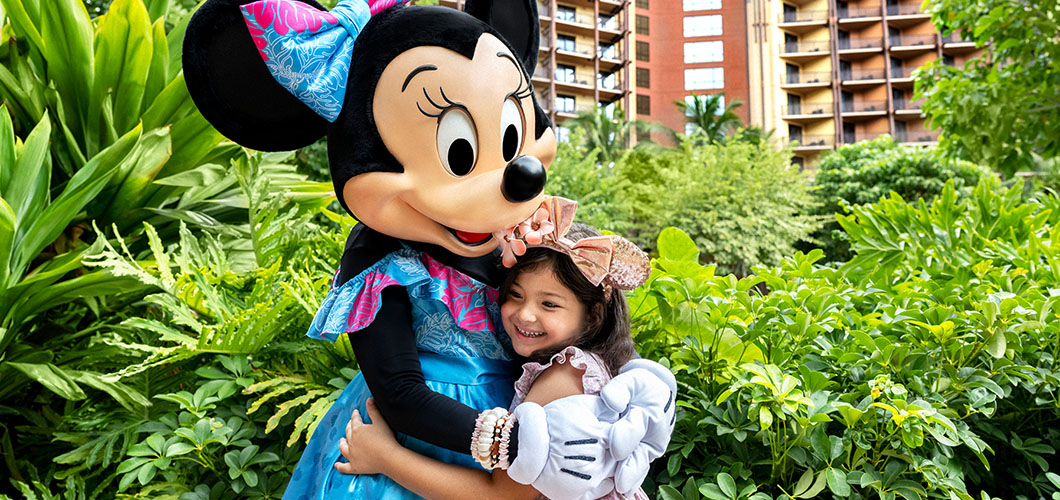 Girl hugging Minnie Mouse