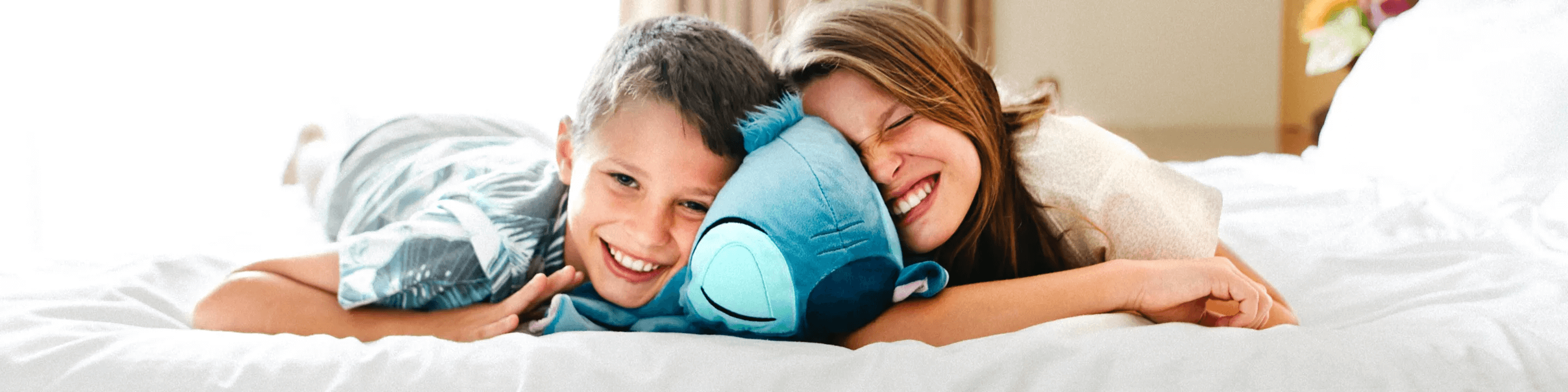 Children hugging lilo and stitch plush toy