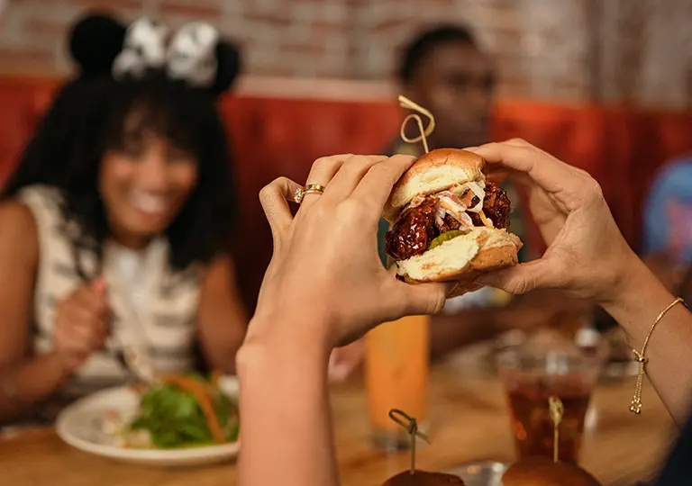 Hands holding a burger