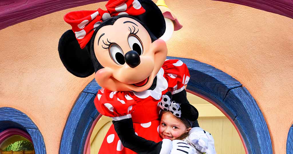 Minnie Mouse and guest hugging
