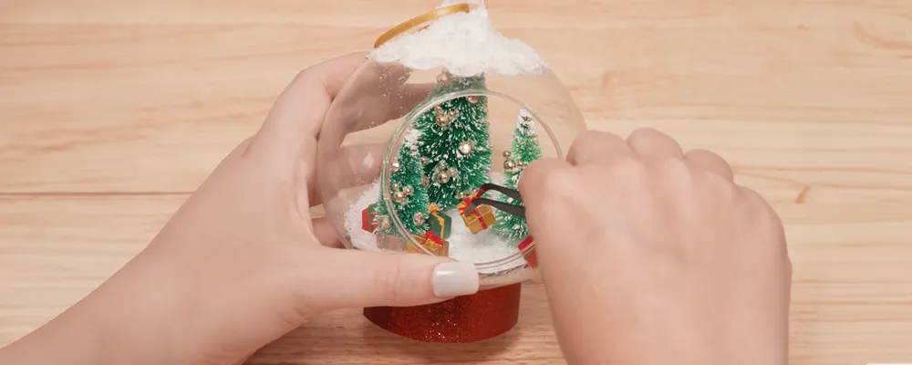 Applying mini gifts boxes on ornament