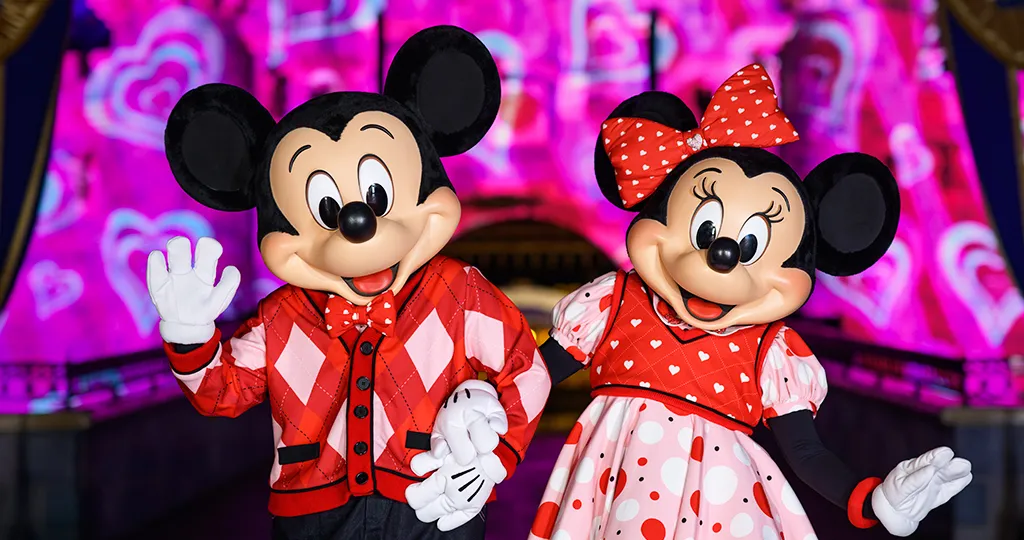 Mickey and Minnie Mouse standing at Sleeping Beauty's Castle on Sweethearts' Nite