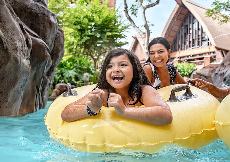 Mom and daughter in the lazy river at AULANI, A Disney Resort & Spa