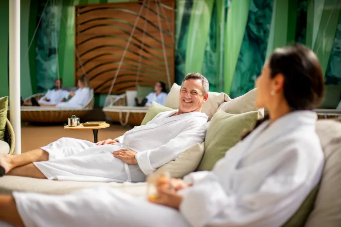 Couple lounging in robes at Disney Cruise Line spa treatment