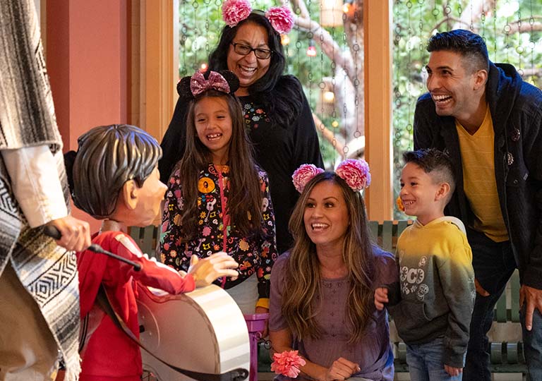 Coco puppet performing to family