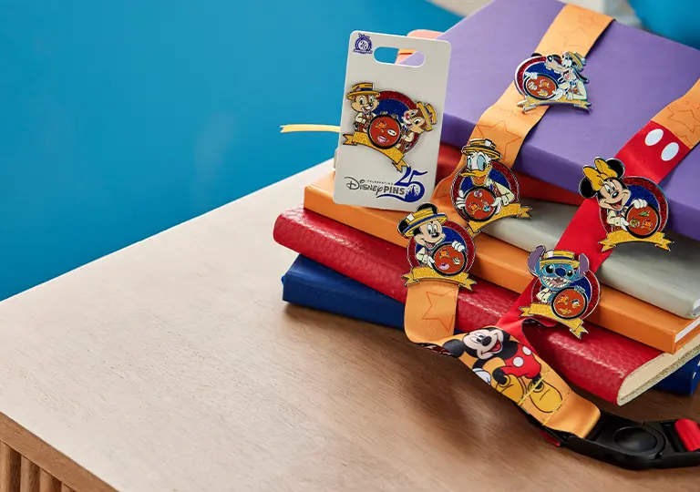 Collectors edition pins on top of books