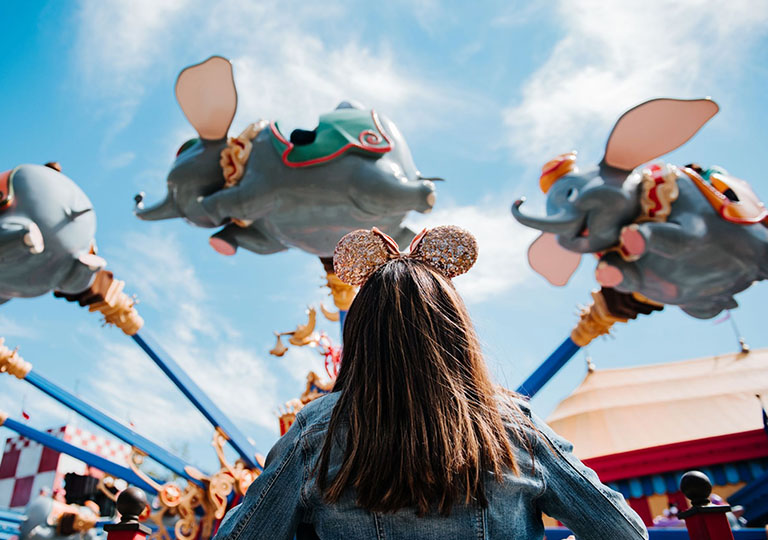 Girl watching Dumbo ride