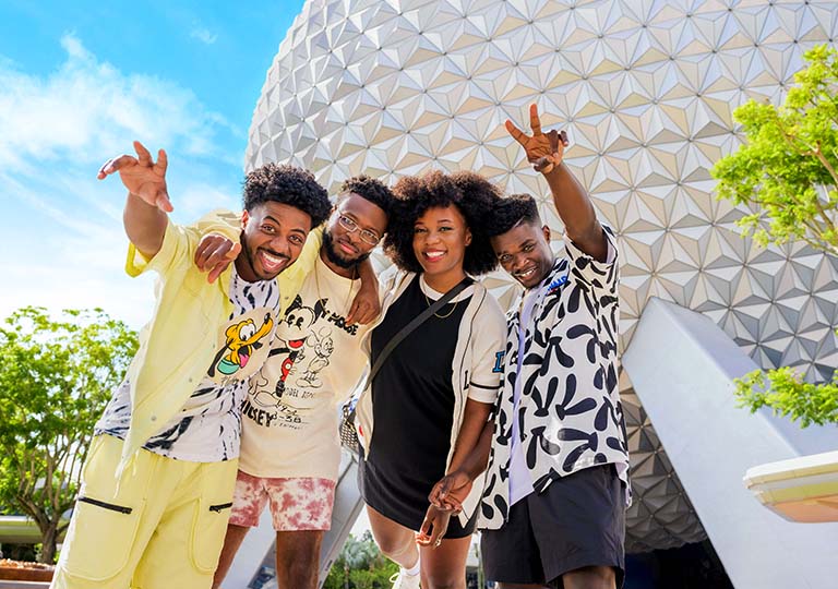 Friends taking a photo in front of Spaceship Earth at Walt Disney World