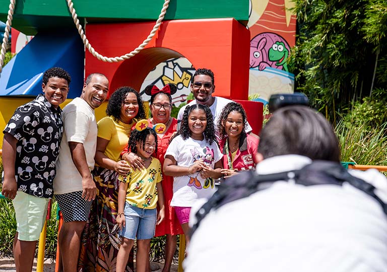 Family getting their photo taken by Disney staff member