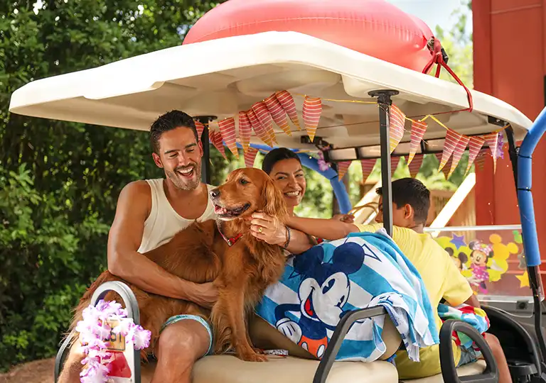 Family with dog on a golf cart