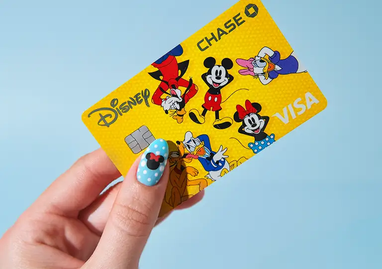 Hand holding Mickey & Friends card