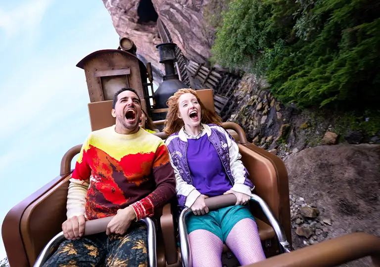 Man and woman having fun riding attraction