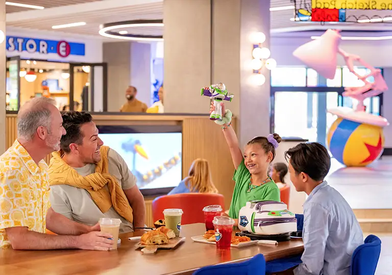 Two men with children at cafe