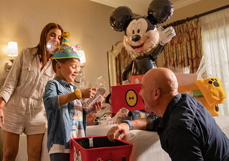 guests with birthday gifts in Disney hotel room