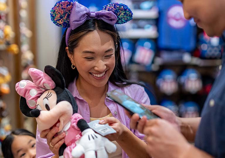 Woman purchasing Disney merchandise