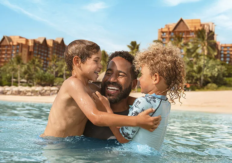 Father and kids swimming