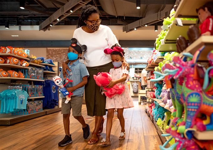 Woman with two kids at a Disney store shopping