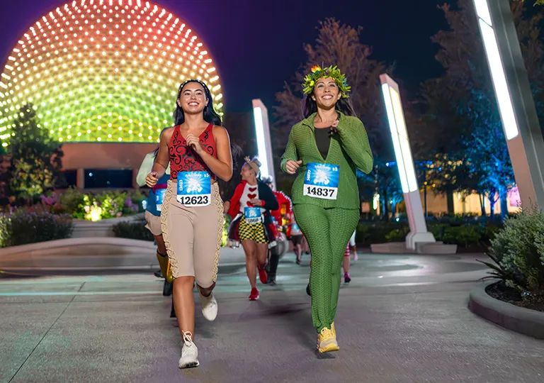 Two women running at EPCOT for runDisney night marathon
