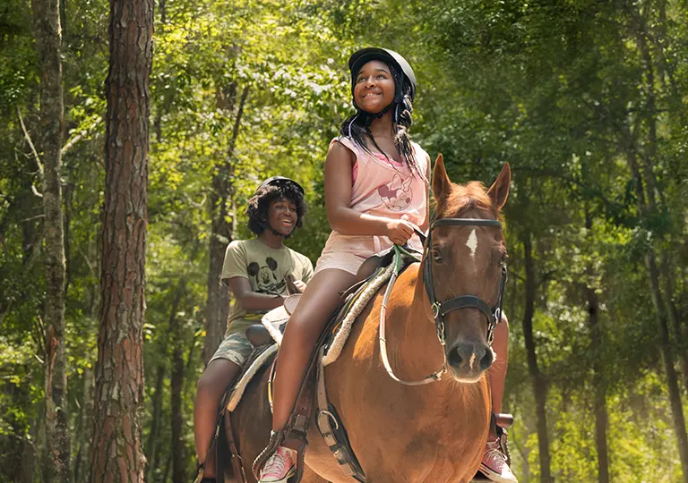 Guests on horseback trail ride