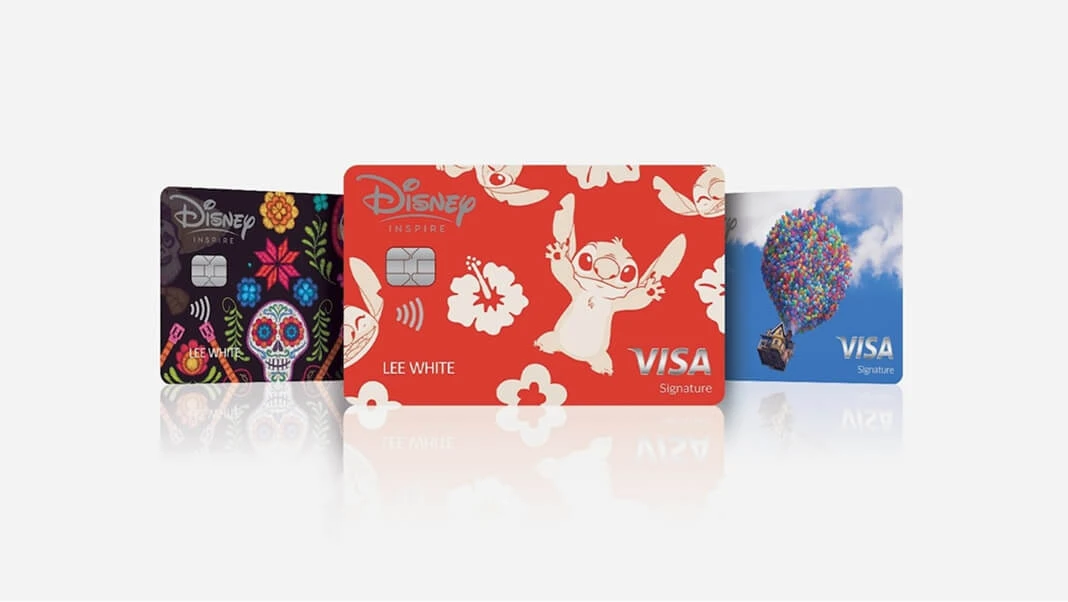 Three Disney Inspire Visa credit cards, each featuring different colorful character artwork for Coco, Lilo & Stitch, and Up.