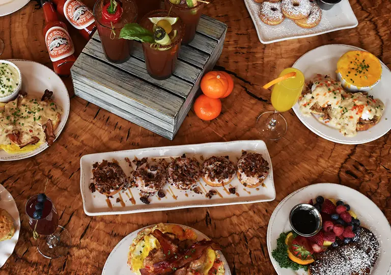 Table with multiple breakfast dishes including Hallelujah Biscuit&nbsp;
