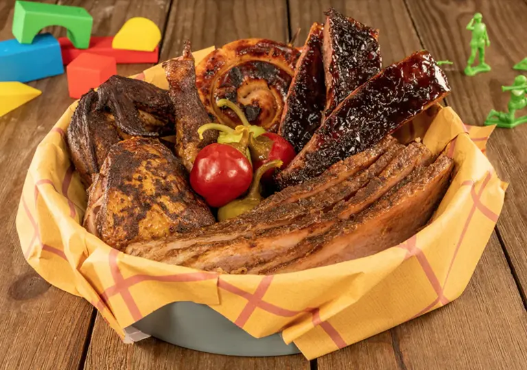fire-grilled pork sausage  served on a platter alongside Evil Dr. Smoked Ribs, Buttercup&rsquo;s Beef Brisket, BBQ Chicken